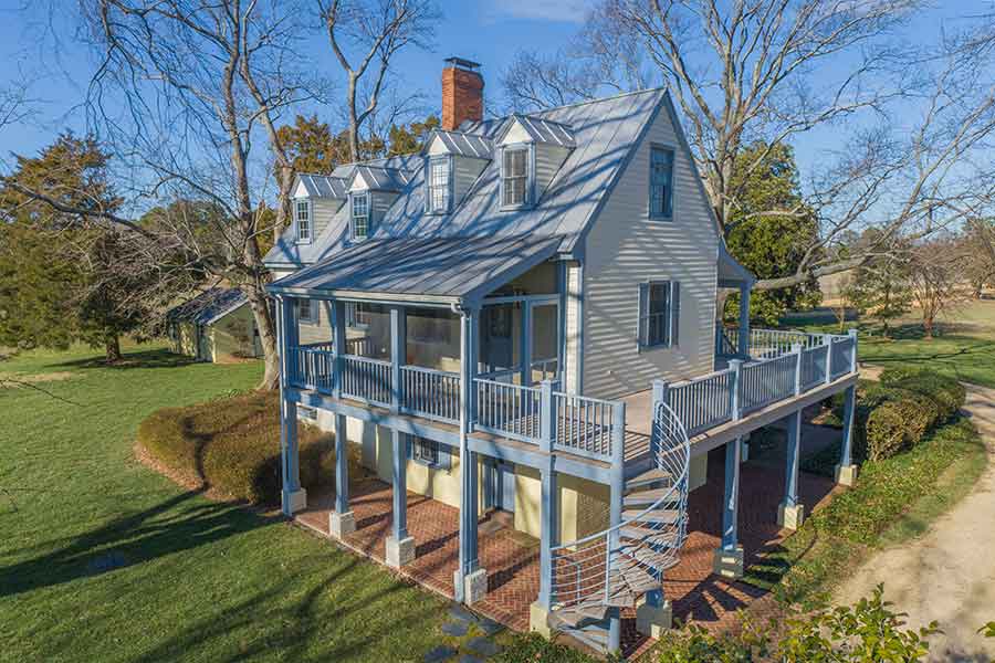 Renovated guest house with wrap around porch and spiral staircase.